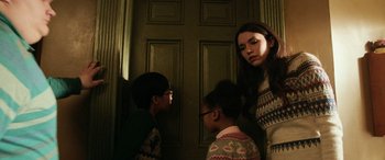Movie still from “Shazam!” (2019), directed by David F. Sandberg – A woman standing next to two young children; Medium shot, Low angle