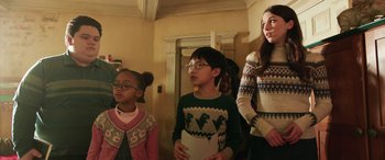 Movie still from “Shazam!” (2019), directed by David F. Sandberg – A group of people standing next to each other in a room; Medium shot, Over the shoulder angle