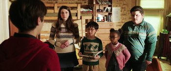 Movie still from “Shazam!” (2019), directed by David F. Sandberg – A woman and two children are standing in a room; Medium shot, Over the shoulder angle