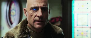 Movie still from “Shazam!” (2019), directed by David F. Sandberg – A bald man with a blue eye is looking at the camera; Close Up shot, Low angle