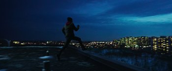 Movie still from “Shazam!” (2019), directed by David F. Sandberg – A man running on a ledge in the dark; Extreme Wide shot, Low angle