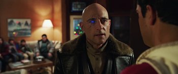 Movie still from “Shazam!” (2019), directed by David F. Sandberg – A bald man with blue eyes wearing a leather jacket; Close Up shot, Over the shoulder angle