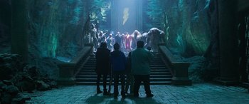 Movie still from “Shazam!” (2019), directed by David F. Sandberg – A group of people standing on some steps in front of a crowd; Wide shot, High angle