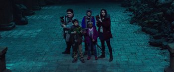 Movie still from “Shazam!” (2019), directed by David F. Sandberg – A group of people standing on a brick road; Medium shot, Low angle