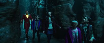 Movie still from “Shazam!” (2019), directed by David F. Sandberg – A group of young people walking in a dark area; Medium shot, Low angle