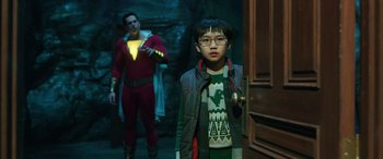 Movie still from “Shazam!” (2019), directed by David F. Sandberg – A young boy standing in front of a door; Medium shot, Over the shoulder angle