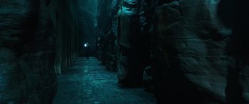 Movie still from “Shazam!” (2019), directed by David F. Sandberg – A person is walking down a dark alley way; Extreme Wide shot, High angle