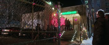 Movie still from “Shazam!” (2019), directed by David F. Sandberg – A group of people standing in front of a neon sign; Extreme Wide shot, High angle