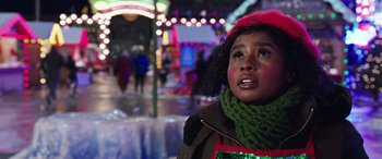 Movie still from “Shazam!” (2019), directed by David F. Sandberg – A young woman wearing a red hat and a green scarf; Close Up shot, Low angle