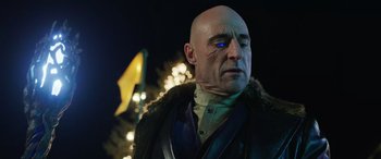 Movie still from “Shazam!” (2019), directed by David F. Sandberg – A bald man wearing a fur coat and a black jacket; Close Up shot, Over the shoulder angle
