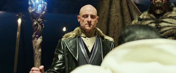 Movie still from “Shazam!” (2019), directed by David F. Sandberg – A bald man in a black leather jacket; Close Up shot, Over the shoulder angle