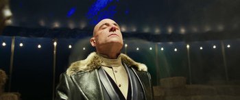 Movie still from “Shazam!” (2019), directed by David F. Sandberg – A bald man in a leather jacket and a fur collar; Close Up shot, Low angle