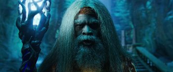 Movie still from “Shazam!” (2019), directed by David F. Sandberg – A man with a beard and long hair; Close Up shot, Low angle