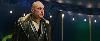 Movie still from “Shazam!” (2019), directed by David F. Sandberg – A bald man wearing a leather jacket with a fur collar; Close Up shot, Low angle