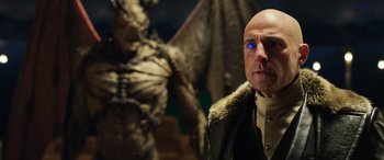 Movie still from “Shazam!” (2019), directed by David F. Sandberg – A man in a leather jacket standing in front of a demon; Close Up shot, Over the shoulder angle