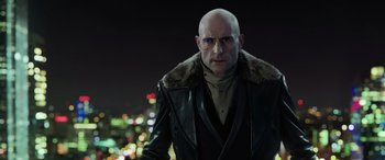 Movie still from “Shazam!” (2019), directed by David F. Sandberg – A bald man wearing a black leather jacket; Close Up shot, Low angle