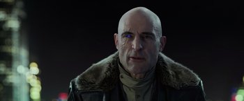 Movie still from “Shazam!” (2019), directed by David F. Sandberg – A man with bald head wearing a fur coat; Close Up shot, Over the shoulder angle