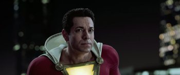 Movie still from “Shazam!” (2019), directed by David F. Sandberg – A person wearing a costume; Close Up shot, Over the shoulder angle
