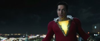 Movie still from “Shazam!” (2019), directed by David F. Sandberg – A man in a red and yellow costume with a yellow light; Medium shot, Low angle