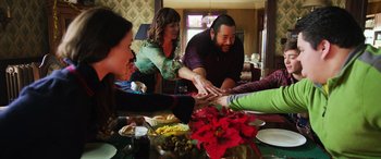 Movie still from “Shazam!” (2019), directed by David F. Sandberg – A group of people sitting around a dinner table; Medium shot, Overhead angle