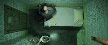 Movie still from “Shazam!” (2019), directed by David F. Sandberg – A man standing on the floor of a bathroom; Wide shot, Overhead angle