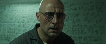 Movie still from “Shazam!” (2019), directed by David F. Sandberg – A bald man wearing glasses and a black shirt; Close Up shot, Low angle