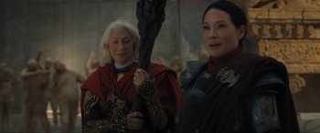 Movie still from “Shazam! Fury of the Gods” (2023), directed by David F. Sandberg – Two women dressed in medieval costumes holding a staff; Medium shot, Over the shoulder angle