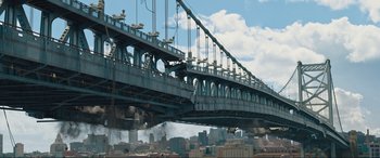 Movie still from “Shazam! Fury of the Gods” (2023), directed by David F. Sandberg – A large bridge that is over a river; Extreme Wide shot, Low angle