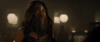 Movie still from “Shazam! Fury of the Gods” (2023), directed by David F. Sandberg – A man with long hair and a long beard; Close Up shot, Over the shoulder angle