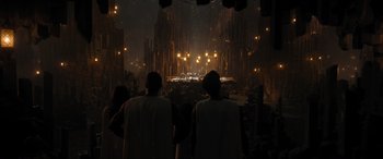 Movie still from “Shazam! Fury of the Gods” (2023), directed by David F. Sandberg – Two people standing in front of a stage with lights; Extreme Wide shot, Low angle