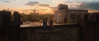 Movie still from “Shazam! Fury of the Gods” (2023), directed by David F. Sandberg – Two people sitting on a ledge at sunset; Extreme Wide shot, High angle