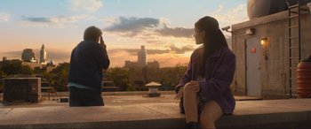 Movie still from “Shazam! Fury of the Gods” (2023), directed by David F. Sandberg – A man and a woman sitting on a ledge; Wide shot, Low angle