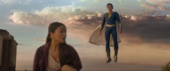 Movie still from “Shazam! Fury of the Gods” (2023), directed by David F. Sandberg – A woman and a man flying through the air; Wide shot, Low angle
