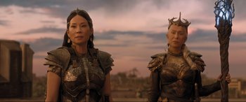 Movie still from “Shazam! Fury of the Gods” (2023), directed by David F. Sandberg – A couple of women standing next to each other on top of a hill; Medium shot, Low angle