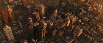 Movie still from “Shazam! Fury of the Gods” (2023), directed by David F. Sandberg – An aerial view of a large city at sunset; Extreme Wide shot, High angle