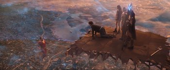 Movie still from “Shazam! Fury of the Gods” (2023), directed by David F. Sandberg – A man and a woman sitting on top of a building; Extreme Wide shot, High angle