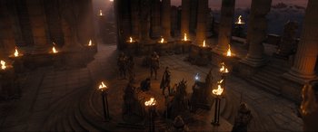 Movie still from “Shazam! Fury of the Gods” (2023), directed by David F. Sandberg – A group of people standing in a circle with torches in front of them; Extreme Wide shot, High angle