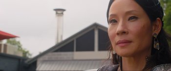 Movie still from “Shazam! Fury of the Gods” (2023), directed by David F. Sandberg – A woman's face in front of a building; Close Up shot, Low angle