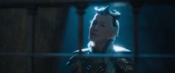Movie still from “Shazam! Fury of the Gods” (2023), directed by David F. Sandberg – An older woman wearing a crown looking off into the distance; Close Up shot, Low angle
