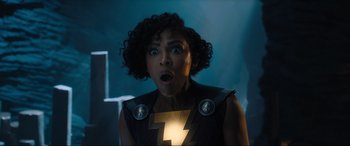 Movie still from “Shazam! Fury of the Gods” (2023), directed by David F. Sandberg – A woman with a surprised look on her face; Close Up shot, Over the shoulder angle
