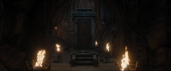 Movie still from “Shazam! Fury of the Gods” (2023), directed by David F. Sandberg – A room with a fire pit and stairs leading up to it; Extreme Wide shot, High angle