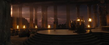 Movie still from “Shazam! Fury of the Gods” (2023), directed by David F. Sandberg – A person standing on a stage in front of pillars; Extreme Wide shot, High angle