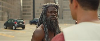 Movie still from “Shazam! Fury of the Gods” (2023), directed by David F. Sandberg – A man with long dreadlocks and a beard; Close Up shot, Over the shoulder angle