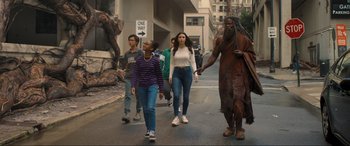 Movie still from “Shazam! Fury of the Gods” (2023), directed by David F. Sandberg – A group of people walking down a street; Wide shot, Low angle