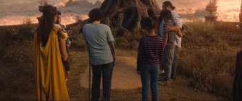 Movie still from “Shazam! Fury of the Gods” (2023), directed by David F. Sandberg – A group of people standing on top of a dirt road; Wide shot, Over the shoulder angle