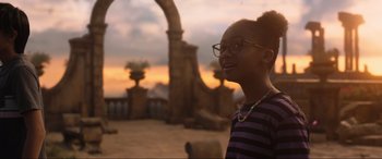 Movie still from “Shazam! Fury of the Gods” (2023), directed by David F. Sandberg – A young woman wearing glasses looking up at the sky; Medium shot, Over the shoulder angle