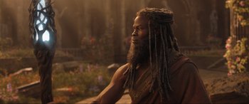 Movie still from “Shazam! Fury of the Gods” (2023), directed by David F. Sandberg – A man with dreads is looking to his left; Close Up shot, Low angle