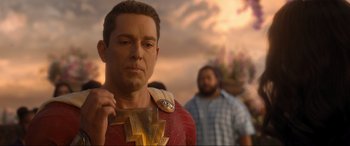 Movie still from “Shazam! Fury of the Gods” (2023), directed by David F. Sandberg – A man in a shazam costume standing in front of a crowd; Close Up shot, Over the shoulder angle