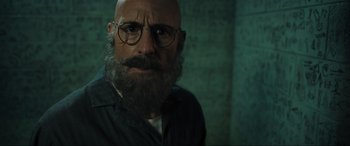 Movie still from “Shazam! Fury of the Gods” (2023), directed by David F. Sandberg – A man with a beard wearing glasses and a black shirt; Close Up shot, Low angle