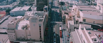 Movie still from “Shelter in Place” (2021), directed by Connor Martin – An aerial view of a city street with cars driving down it; Extreme Wide shot, High angle